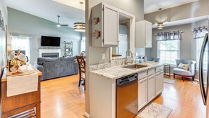 A modern kitchen with a dishwasher, a built-in oven, and a large island with a sink. - Wilmington Family Home: 6 Mi to Wrightsville Beach (Wilmington)
