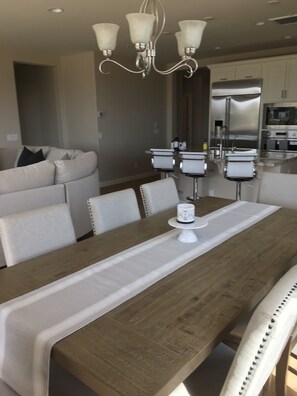 Enjoy meals in the spacious kitchen and dining area, featuring a microwave, refrigerator, and oven.