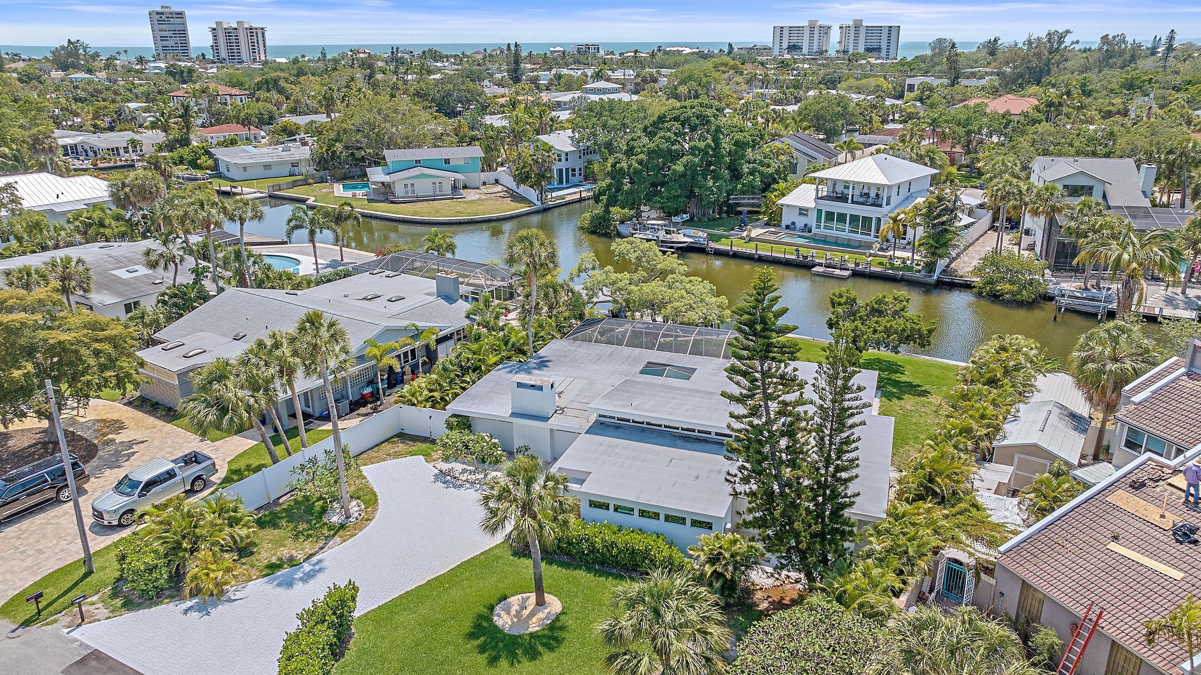 A residential area with houses, a marina, and a body of water.