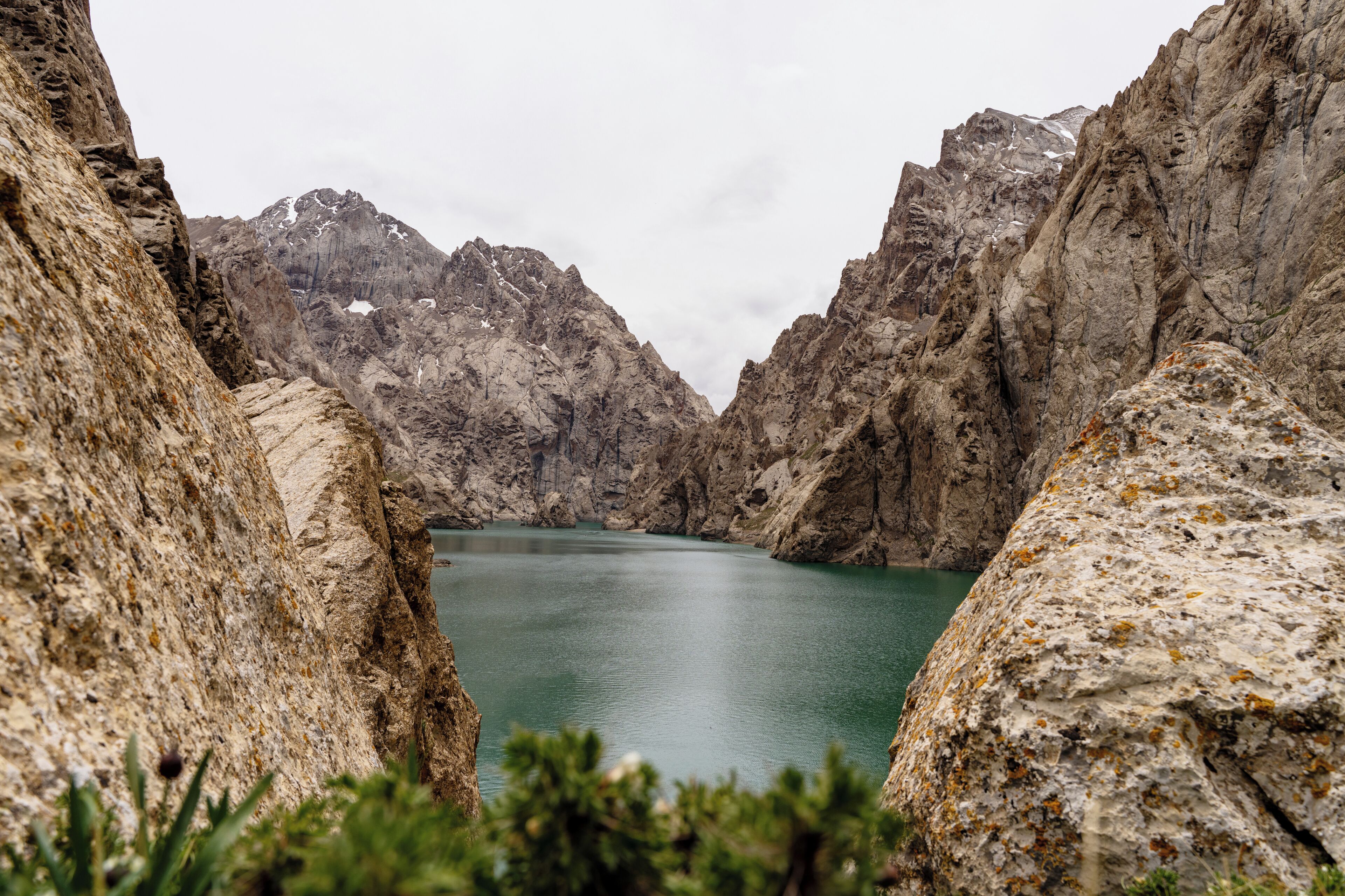 A natural landscape with a lake surrounded by rocky cliffs.