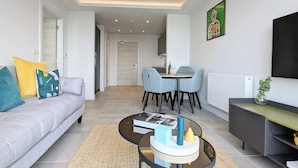 A modern living room with a sofa, coffee table, and dining area. - Charles Hope Manchester Centre (Manchester)