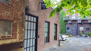 A brick building with a sign for 'Suites The Loxley UNIT 1'. - Sosuite | 2BR Apt w Laundry, Private Entrance (Philadelphia)