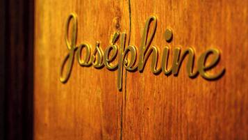 A wooden surface with the name "Josephine" engraved in a cursive, metallic font.
