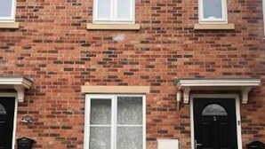 A two-story brick house with a black car parked in front. - Stunning 3-bed House in Bristol (Bristol)