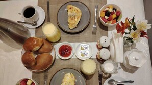 A breakfast setting with various dishes, including eggs, pastries, and fruit. - Casa Cruz Verde by Peru Garden Hotels (Cusco)