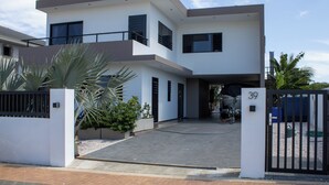 A modern two-story house with a gated entrance, a driveway, and a number 39 sign. - Luxury Villa Incl Pool With Seaview Near Beaches (Grote Berg)