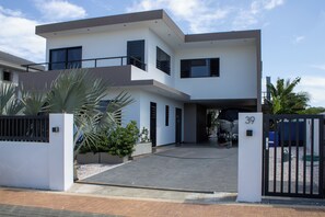 A modern two-story house with a gated entrance, a driveway, and a number 39 sign. - Luxury Villa Incl Pool With Seaview Near Beaches (Grote Berg)