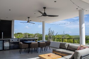 An outdoor patio with a dining table, chairs, a sofa, and a ceiling fan. - Luxury Villa Incl Pool With Seaview Near Beaches (Grote Berg)