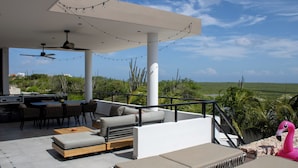 An outdoor patio with seating, a dining area, and a view of the landscape. - Luxury Villa Incl Pool With Seaview Near Beaches (Grote Berg)