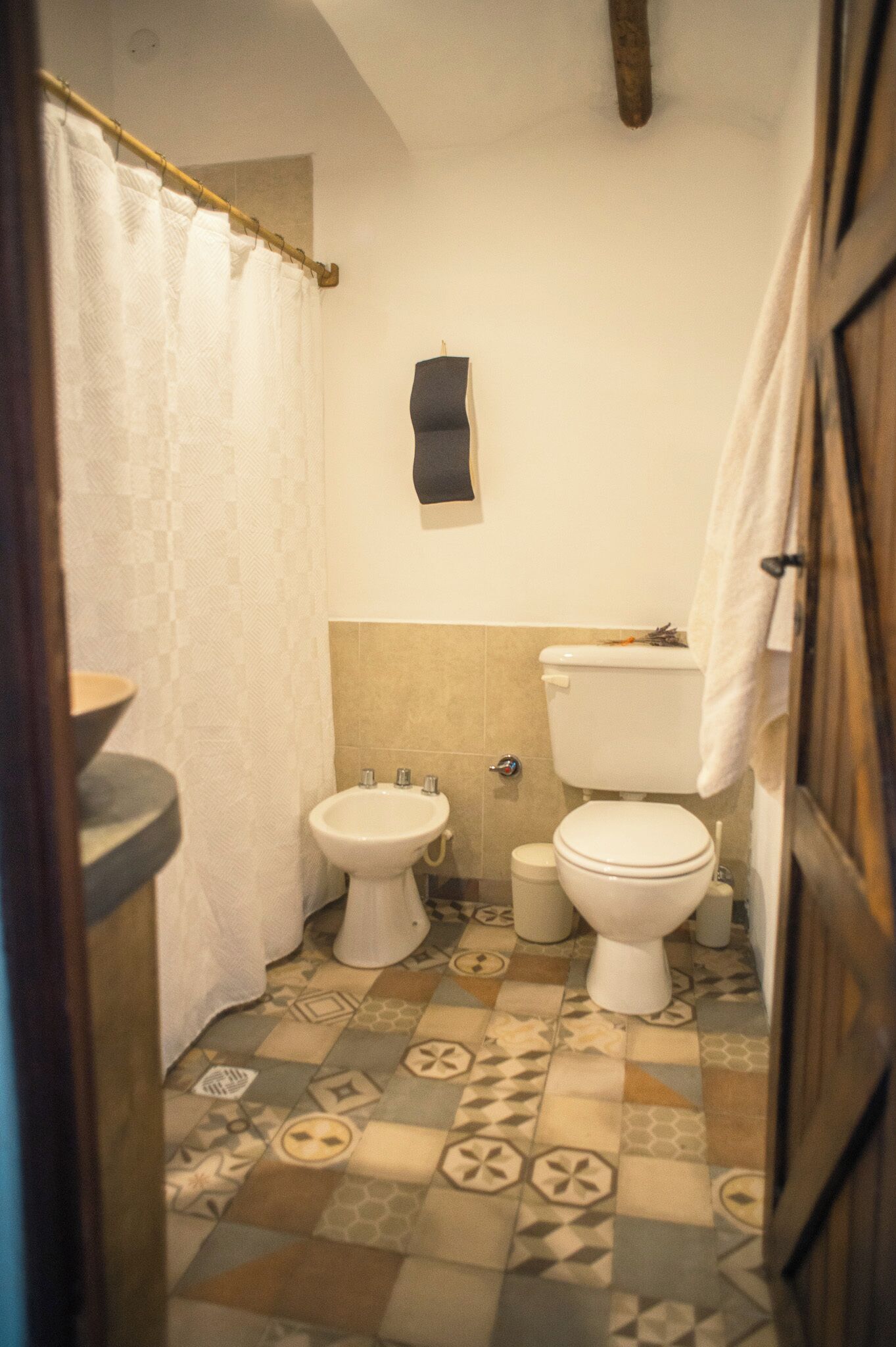 A bathroom with a toilet, bidet, and sink.
