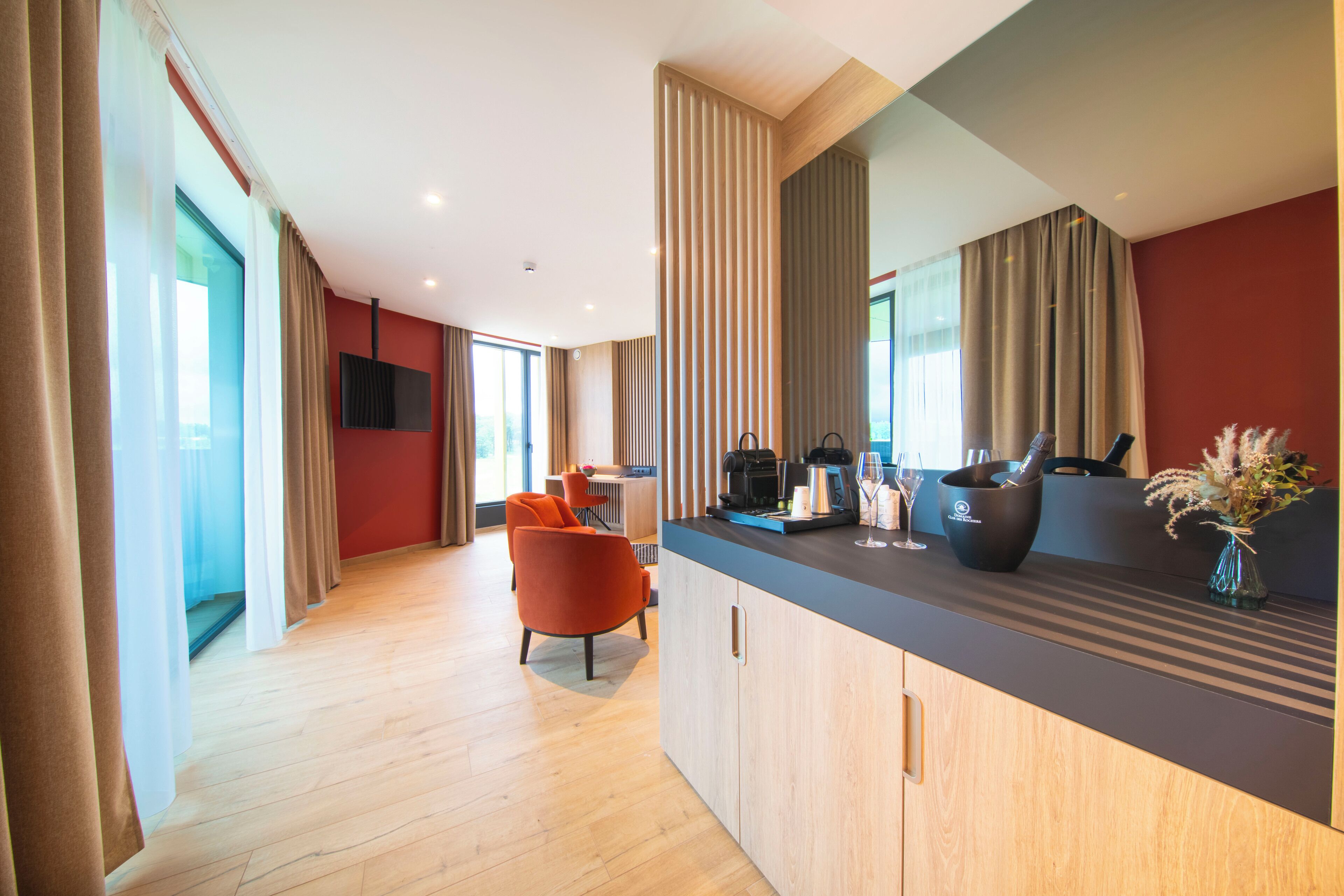 A modern kitchen with a wooden countertop, a built-in stove, and a coffee machine.