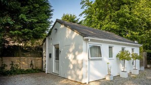 A small, single-story house with a sloped roof, a front door, and a small porch area. - Cozy City Retreat in Bristol With Parking & Patio (Bristol)