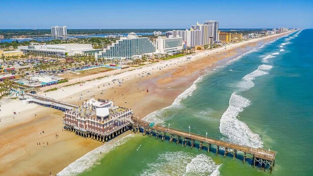 A coastal cityscape with a beach, a pier, and high-rise buildings. - Pool Oasis 2 Blocks from Beach (Port Orange)