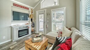 A living room with a fireplace, TV, and a cozy seating area.