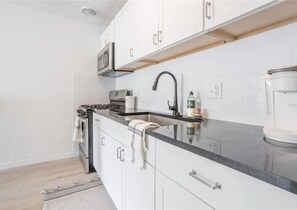 Fridge, microwave, oven, stovetop - Modern, Sunlit Condo Near UF - Walkable Location! (Gainesville)