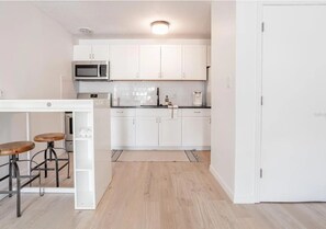 Fridge, microwave, oven, stovetop - Modern, Sunlit Condo Near UF - Walkable Location! (Gainesville)