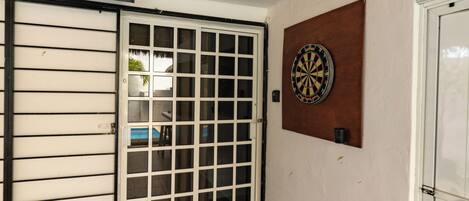 A room with a thatched roof, a dartboard, and a sign for 'Jack Rackham's'.