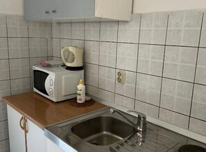 Fridge, microwave, stovetop, cookware/dishes/utensils