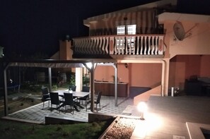 Enjoy a meal on the ground floor patio or take in the view from the upper floor balcony.