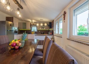 Enjoy meals in this kitchen with a central island, oven, and sink, perfect for cooking and dining.