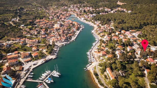 An aerial view of a coastal town with a marina, dense housing, and surrounding greenery. - Hvar spa & apartments-1 Bedroom-Terrace/Sea View 3 (Vrboska)