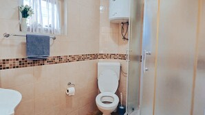 A bathroom with a toilet, a sink, a shower, and a window with curtains. - Hvar spa & apartment-2 Bedroom-Terrace/Sea View 4 (Vrboska)