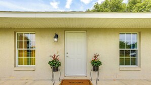 A house with a white door, two windows, and a welcome mat. - Idyllic Anthony Home: Riding Arena w/ Mirror Wall! (Anthony)