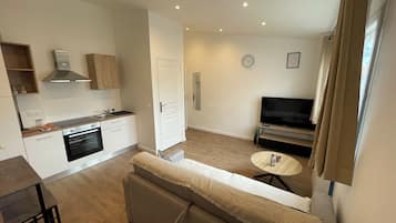 Comfort Apartment | Living area | 50-inch Smart TV with cable channels, Netflix, pay movies