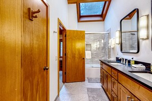 Enjoy a spacious bathroom with a large vanity, dual sinks, and a walk-in closet.