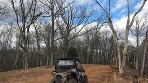 A dirt path with a quad bike parked on the side. - RV Site #42 pull through - Big Rig Friendly 65ftx28ft (Hardin)
