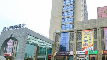 A hotel with a modern facade, large windows, and a prominent entrance.