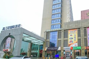 A hotel with a modern facade, large windows, and a prominent entrance. - Sanhe International Hotel (Jinhu)