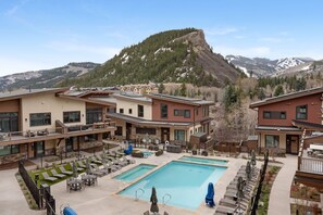 A resort with a pool, outdoor seating, and mountain views. - Charlie Rentz: One Riverfront, Gondola Access, Ski Valet, Resort + Spa, Pool + Hot Tubs (Avon)