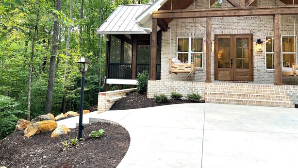 A rustic cabin with a stone facade, wooden beams, and a porch with a swing seat. - Hickory Cottage - 1bdrm Retreat (Taylors)