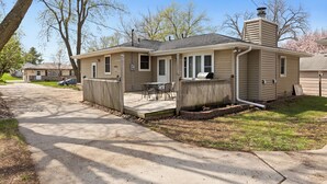 A single-story house with a front porch, a small attached garage, and a visible chimney. - Beautiful home minutes from downtown!  (Des Moines)