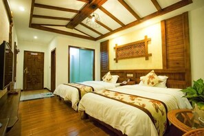 A hotel room with two beds, wooden flooring, a wooden ceiling, and a wall-mounted TV. - Jinhua Inn (Zhangjiajie)