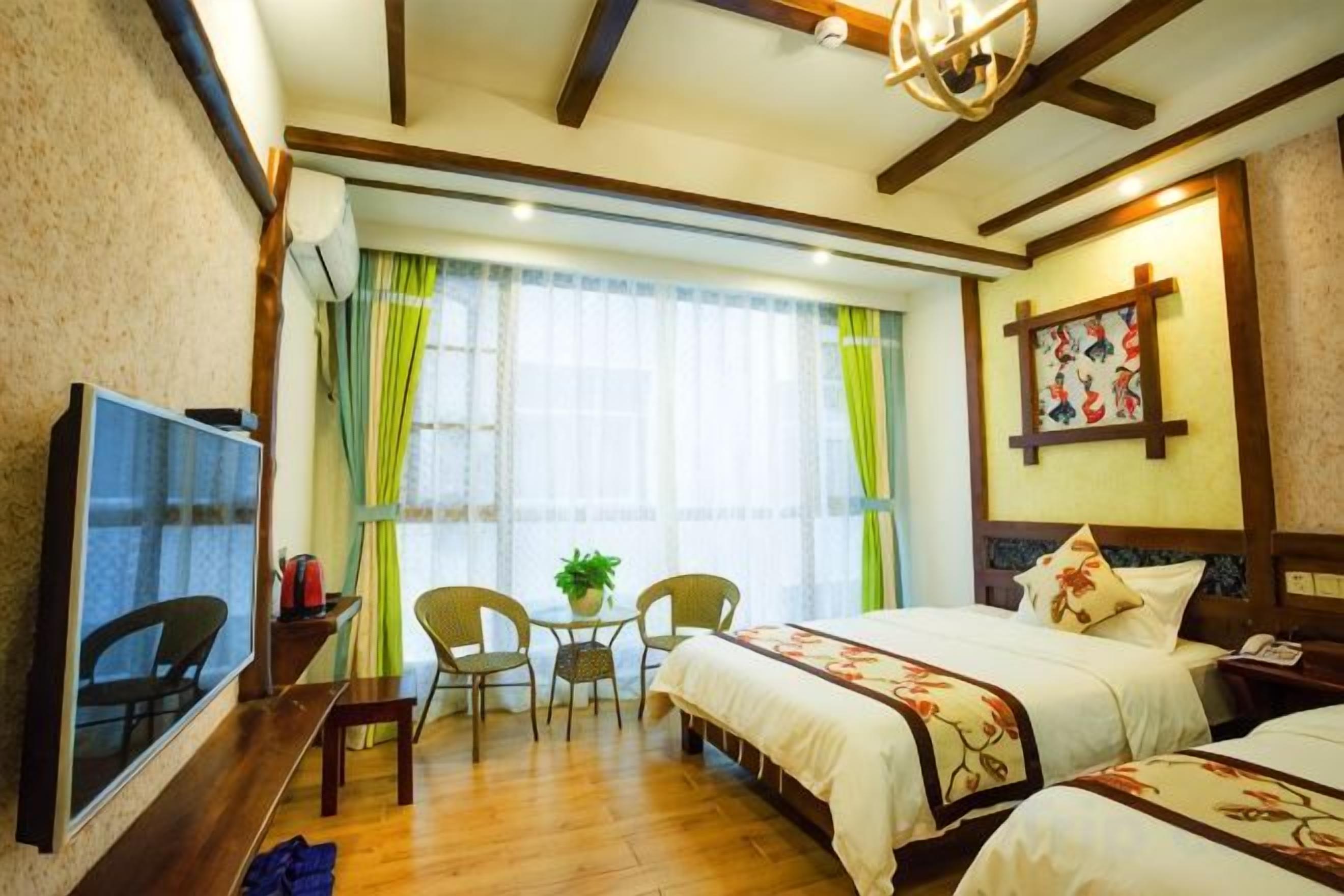 Una habitación de hotel con cama, televisión, escritorio y una silla.