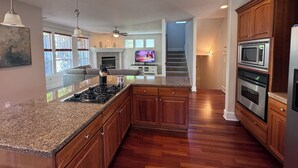 A modern kitchen with granite countertops, wooden cabinets, a built-in microwave, and a gas stove. - Spacious 5 Bedrooms, 7 beds - Sleeps Large Groups (Portland)