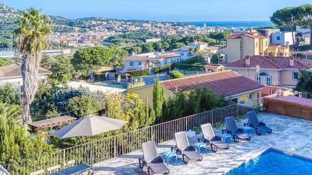 A pool area with lounge chairs and a view of a coastal cityscape. - Villa "Costacabana - Abigail" with Sea View, Private Pool & Wi-Fi (Lloret De Mar)