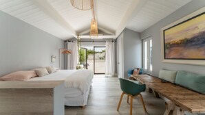 A modern bedroom with a bed, a wooden bench, and a large window. - Holiday Home "Le Cabanon de Modène" with Mountain View, Wi-Fi and Air Conditioning (Modène)