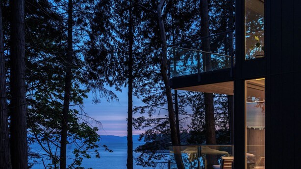A modern cabin with a glass balcony overlooking a forest and a body of water. - Tsuga Beach Inn - Waterfront Retreat - NEW - Mahonia Room (Sechelt)