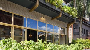 A building with multiple balconies, some with plants, and large windows. - Golden Valley Hotel (Medellín)