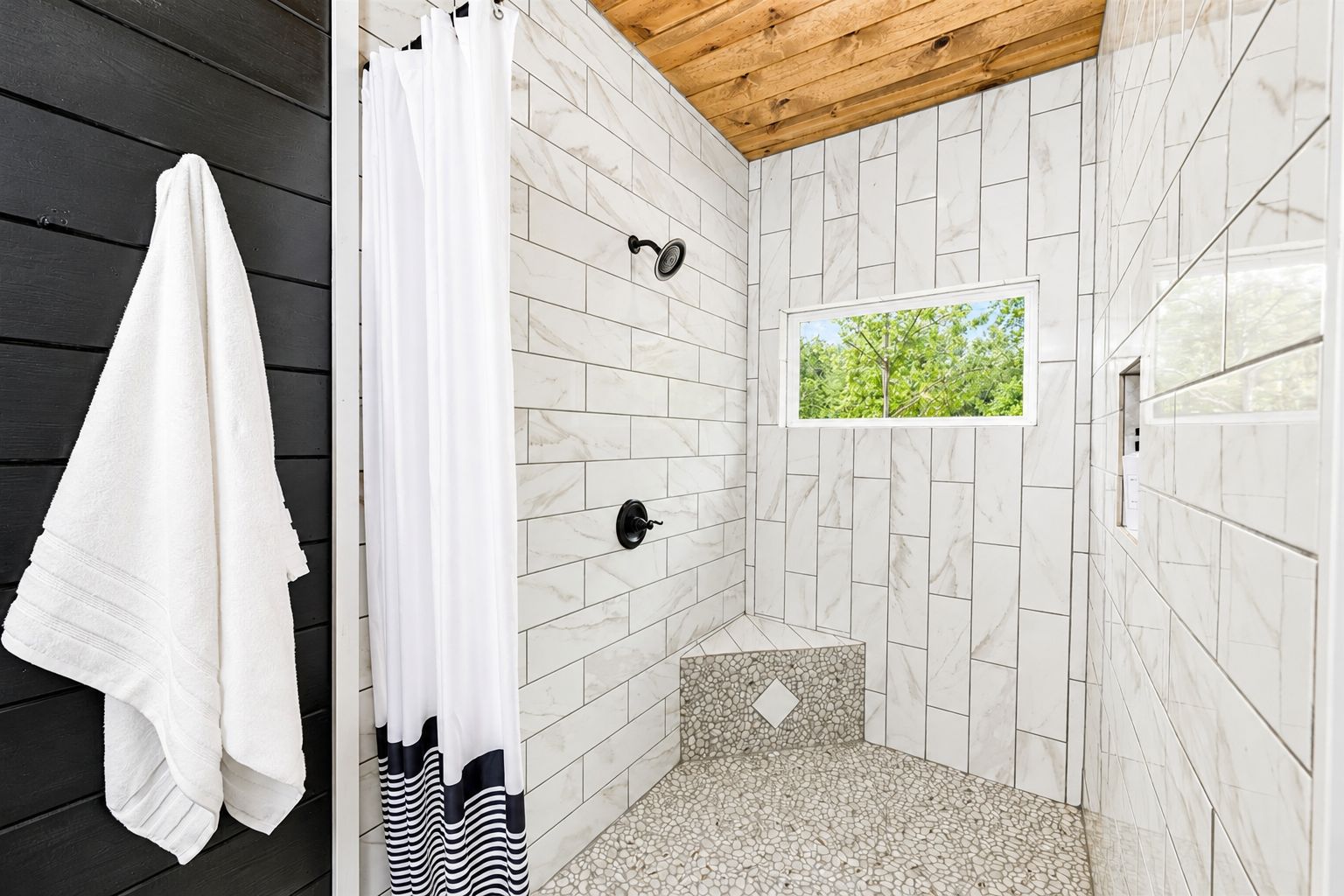 Bathe in the large shower with a view of the forest!