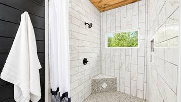 Bathe in the large shower with a view of the forest!