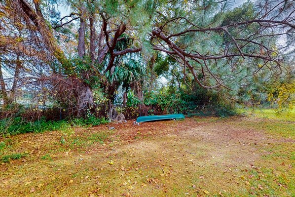 Situated amidst lush trees and foliage, this serene natural setting offers a peaceful escape.