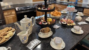 A kitchen counter with a variety of pastries, cookies, and a teapot. - Family Retreat 29 Miles to Yellowstone in a Quiet Wooded Area, with a Kids Nook (Island Park)