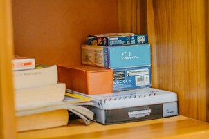 A shelf with books, a box labeled "Calm," and a device with "BACKPACKER" branding.