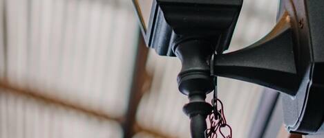 A black lantern with a chain hanging from it.