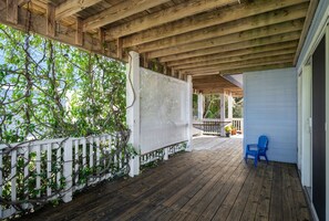 A wooden deck with a white picket fence and a blue chair. - Cloudbreak: Pet Friendly, Oceanside, Hot Tub, Community Amenities! (Duck)