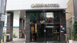The exterior of the Ion Hotel with a modern entrance, glass doors, and a visible sign for room number 313-6. - ION HOTEL DONGDAEMOON (Seoul)